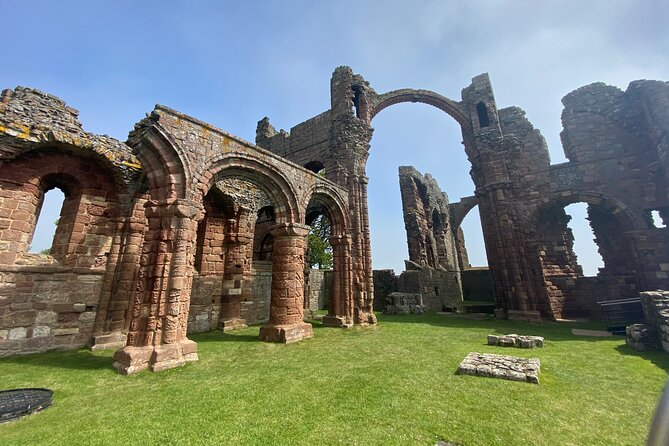 Edinburgh: Bamburgh, Northumberland & Alnwick Winter Adventure - Holy Island and Lindisfarne Gardens: Priory views plus the tide-timing drama