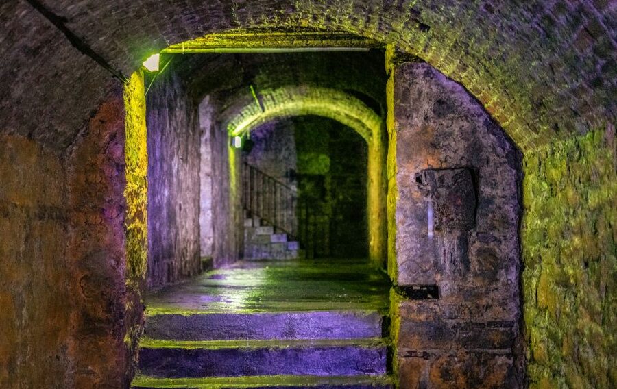 Edinburgh: Haunted Underground Vaults and Graveyard Tour - Entering the Edinburgh Vaults under South Bridge: the arches, the step, and the “how could this be real” feeling